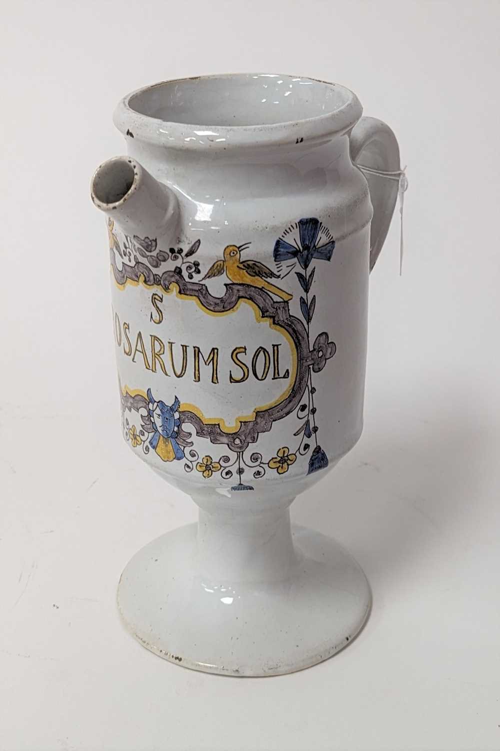 A 19th century polychrome tin-glazed wet drugs jar, inscribed Rosarum Sol within a cartouche, h.