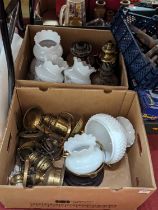 A collection of Victorian and later oil lamp parts, to include shades and burners