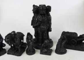 A black resin figure group of four miners, modelled standing, h.24cm; together with six others