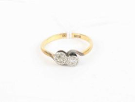 An 18ct gold and platinum diamond set crossover ring, arranged as two small illusion set round cuts,