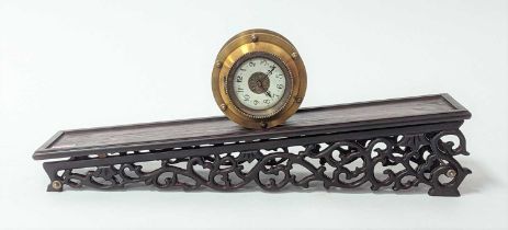 A reproduction brass gravity driven incline rolling clock, the enamel dial showing Arabic