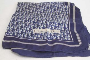 A blue and white silk scarf with geometric motif, bearing the name Christian Dior