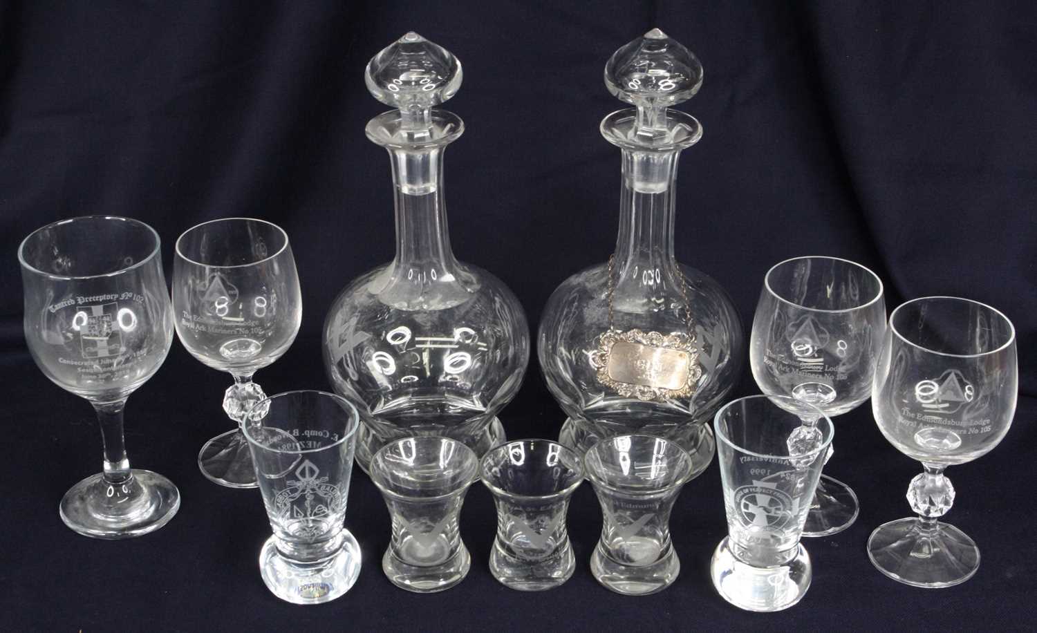 A pair of Masonic cut glass decanters, each having a mushroom stopper to a fluted neck and bulbous