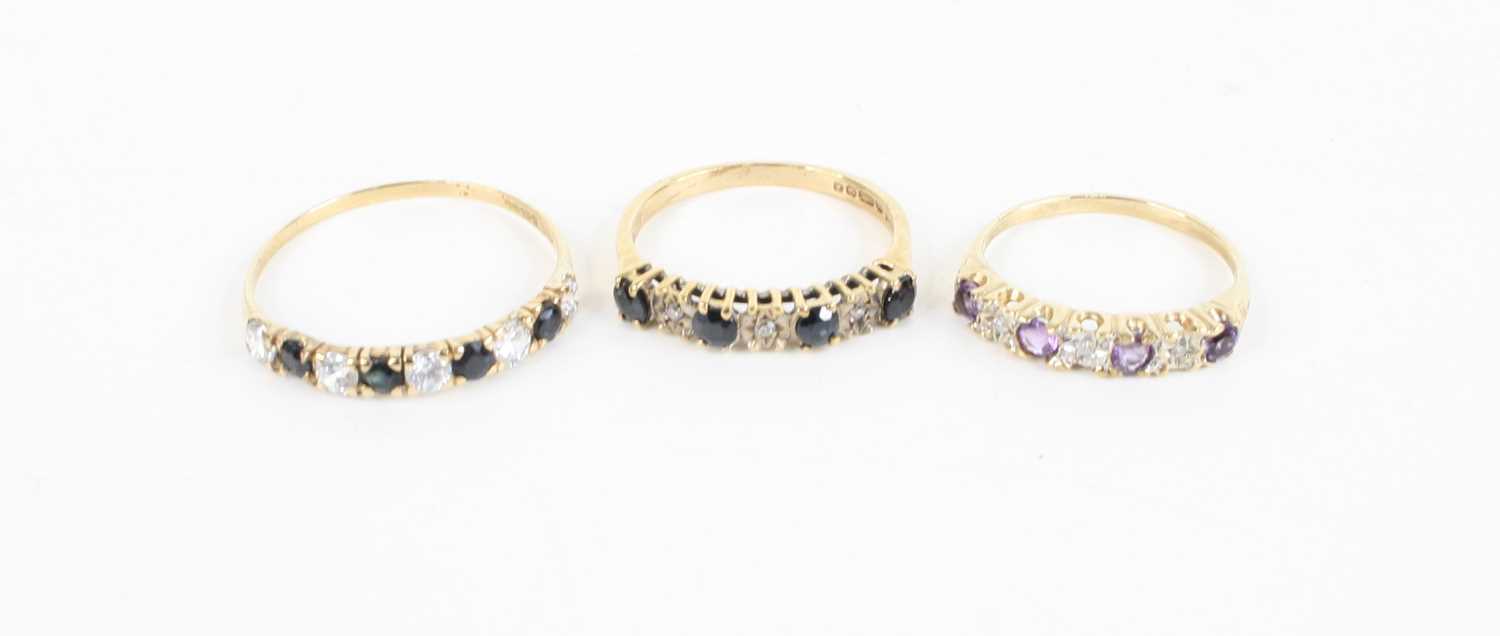 A 9ct gold, blue and white sapphire set half hoop ring, size T; together with one other similar; and