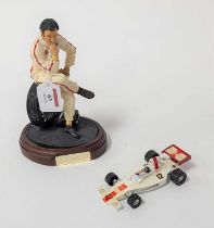 An Endurance The Art of Sports Series Graham Hill figurine, modelled seated on a tyre, on further