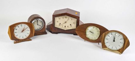 An Art Deco walnut cased mantel clock of geometric shape, having brushed silvered dial with