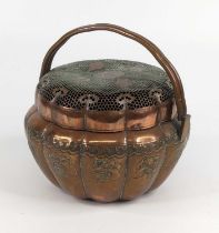 A Chinese copper hand warmer, 19th century, of melon form, with twin carrying handles, decorated