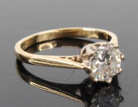 A 9ct yellow and white gold diamond solitaire ring, comprising a round brilliant cut diamond in an