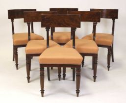 A set of six late Regency mahogany barback dining chairs, each with stuffover seats and raised on