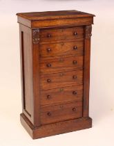 An early Victorian rosewood Wellington secretaire chest arranged as six long drawers, the top two as