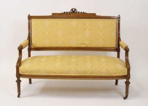 A circa 1900 walnut framed salon settee, having stuffover seat, back and arms, the back with