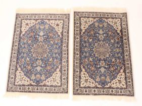 A pair of Persian woollen small rugs, each decorated in the Blue Nain pattern, with trailing
