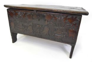 A small 17th century provincial oak six-plank blanket chest, having later floral urn relief carved