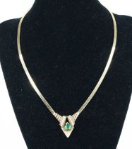 A 14ct yellow gold emerald and diamond necklace by Bellarri, featuring a pear cut emerald claw set