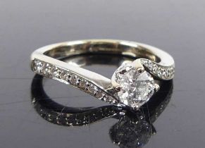 A white metal Tolkowsky diamond solitaire ring, featuring a round brilliant cut diamond in a four-