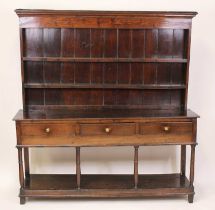 A mid 18th century joined oak dresser, the upper section having an ogee moulded cornice and plain