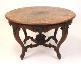 A late 19th century continental rosewood and floral marquetry inlaid centre table, the circular