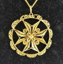 A yellow metal filigree work Maltese cross pendant, within a circular surround and suspended from