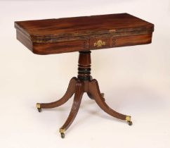 A Regency mahogany and rosewood crossbanded pedestal tea table, having a fold-over top with swivel