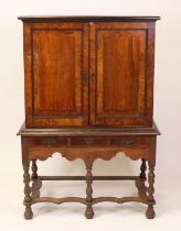 An early 19th century rosewood and burr oak cross banded cupboard on associated stand in the early