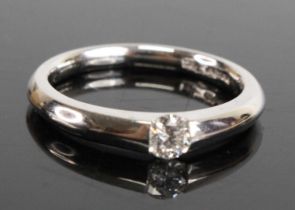 A platinum diamond solitaire ring, featuring a round brilliant cut diamond in a semi-tension