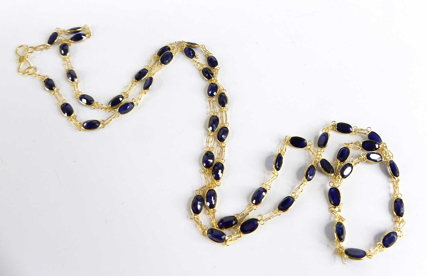 A yellow metal sapphire multi-stone necklace, comprising 49 oval sapphires in bezel setting, with - Image 2 of 3