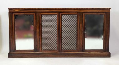 A Regency rosewood side cabinet having twin end mirrored doors enclosing a shelved interior, and
