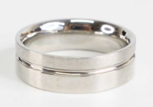 A platinum 6.8mm flat court shaped ridged wedding band, having satin and polished detail, size