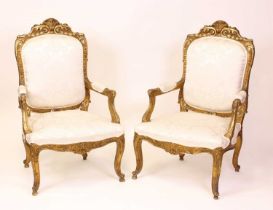 A pair of circa 1900 French gilt wood fauteuil, in the Régence style, the elegant frames floral
