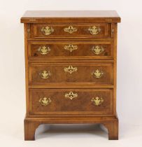 A walnut and burr walnut bachelor's chest of small proportions and in the early 18th century