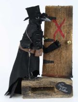 An anthromorphic taxidermy Plague Doctor Carrion Crow (Corvus corone), mounted standing in black hat