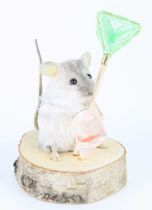 An anthropomorphic taxidermy White mouse (Mus musculus), modelled standing with a goldfish in bag