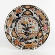 A Japanese Imari porcelain charger, 18th century, decorated with a vase of flowers, dia.29cm Some