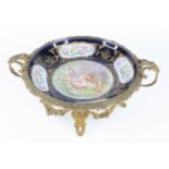 A circa 1900 Sèvres style porcelain table bowl, housed in floral cast twin handled gilt metal