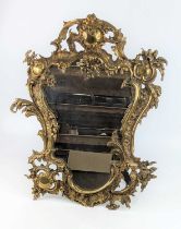 A large brass easel mirror, 19th century, in the Rococo taste, decorated with C-scrolls and