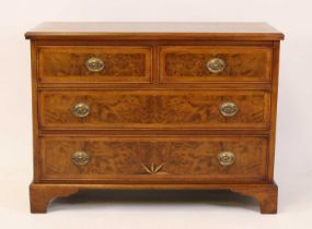 A walnut and figured walnut chest in the early 18th century style, having a feather and