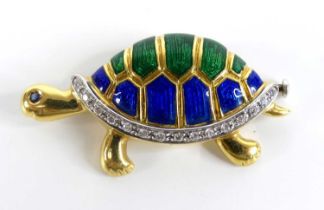 A yellow metal diamond set tortoise brooch, having blue and green enamel detail to the shell and a