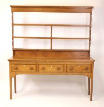 A George III joined blond oak and elm dresser, the upper section having a plain frieze and three-