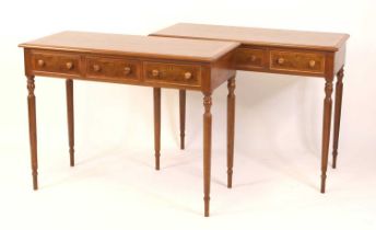 A pair of walnut and figured walnut side tables, each having three feather banded frieze drawers and