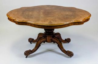 *A Victorian walnut and figured walnut pedestal loo table, having a four-quarter veneered shaped