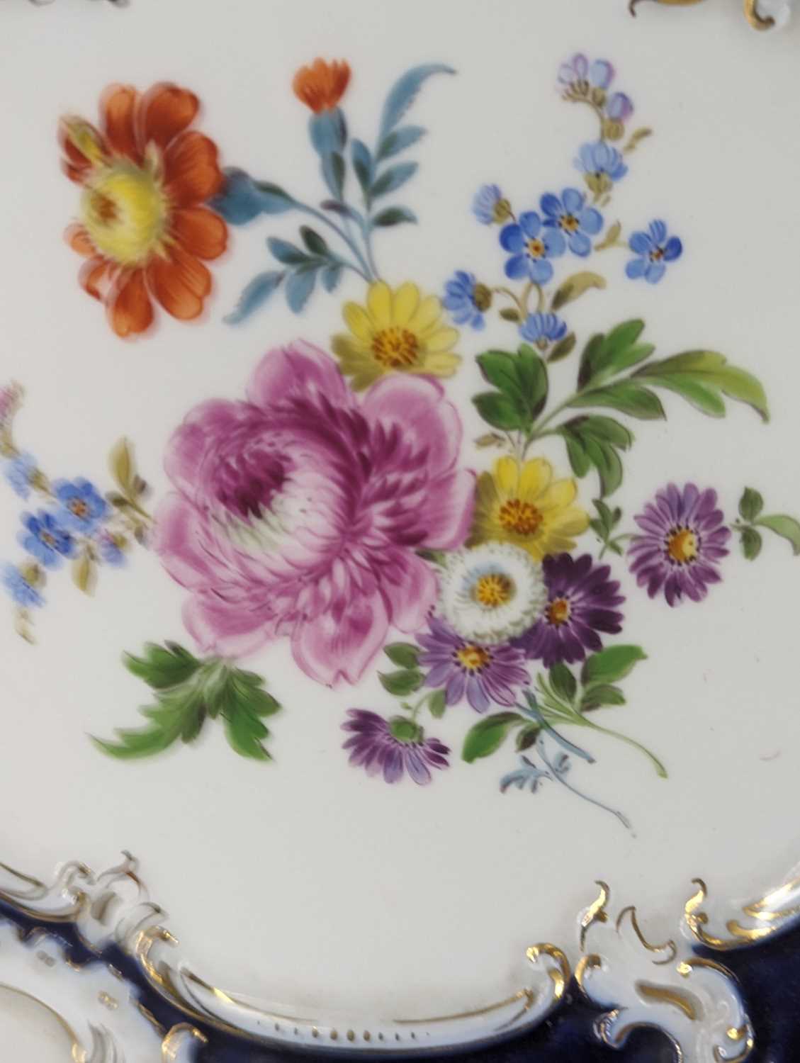 A Meissen porcelain cabinet plate, enamel decorated with flowers within a blue and gilt border, - Image 4 of 4