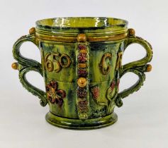 A Castle Hedingham green and yellow glazed pottery tyg, the body having four strap handles, relief