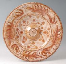 An Hispano-Moresque copper lustre earthenware charger, 16th/17th century, with foliate decoration