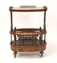 A Victorian figured walnut and marquetry inlaid Canterbury whatnot, of oval outline, the top with