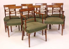 A set of eight late Georgian mahogany dining chairs each having bar backs with conch shell marquetry