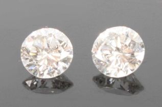 A pair of loose round brilliant cut diamonds, one measuring approx 6.52 x 4.15mm and calculated as