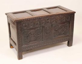 A circa 1700 joined oak coffer having three panel lid on replacement brass hinges, opening to reveal