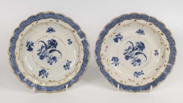 A pair of Caughley porcelain plates, circa 1785, each decorated with flowers and heightened in gilt,