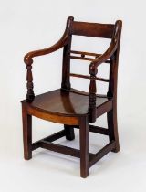 An early 19th century mahogany and fruitwood East Anglian child's elbow chair, having a bar and ball