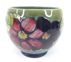 An early 20th century Moorcroft Poppies pattern pottery footed jardiniere, of bulbous form,